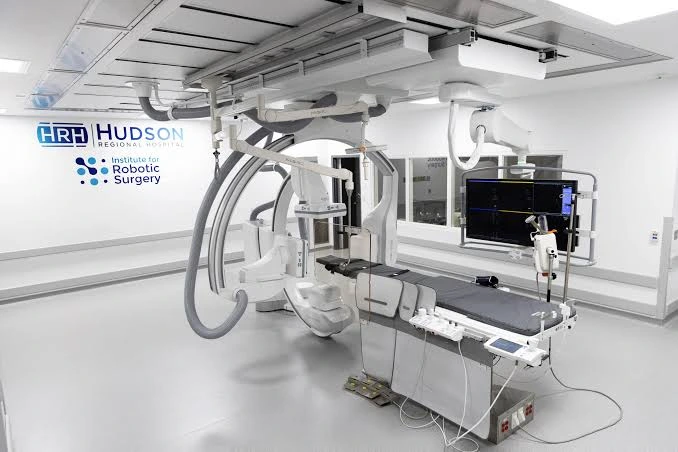 Cardiology Puns about interventional cardiology featuring a clean catheterization laboratory and medical monitoring equipment